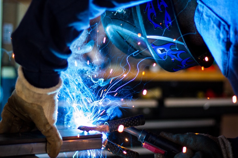 person welding, manufacturing industry
