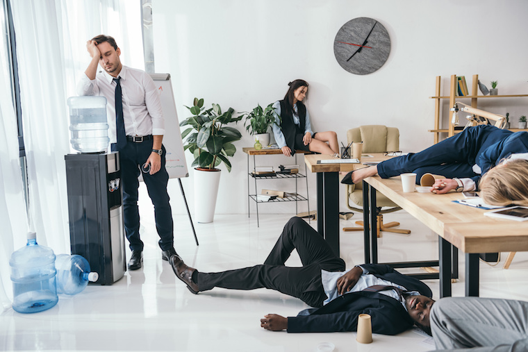 group of exhausted business partners sleeping at office