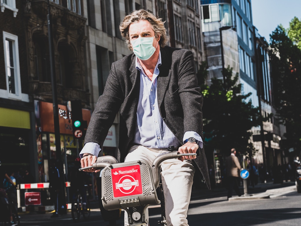 c40 cities emissions man on bike with mask