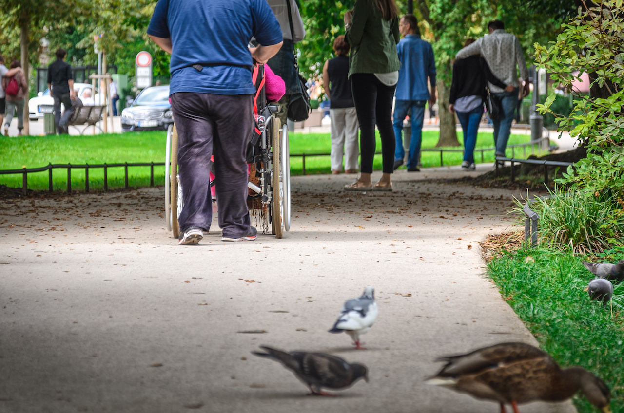 Passers-by on the street and a wheelchair