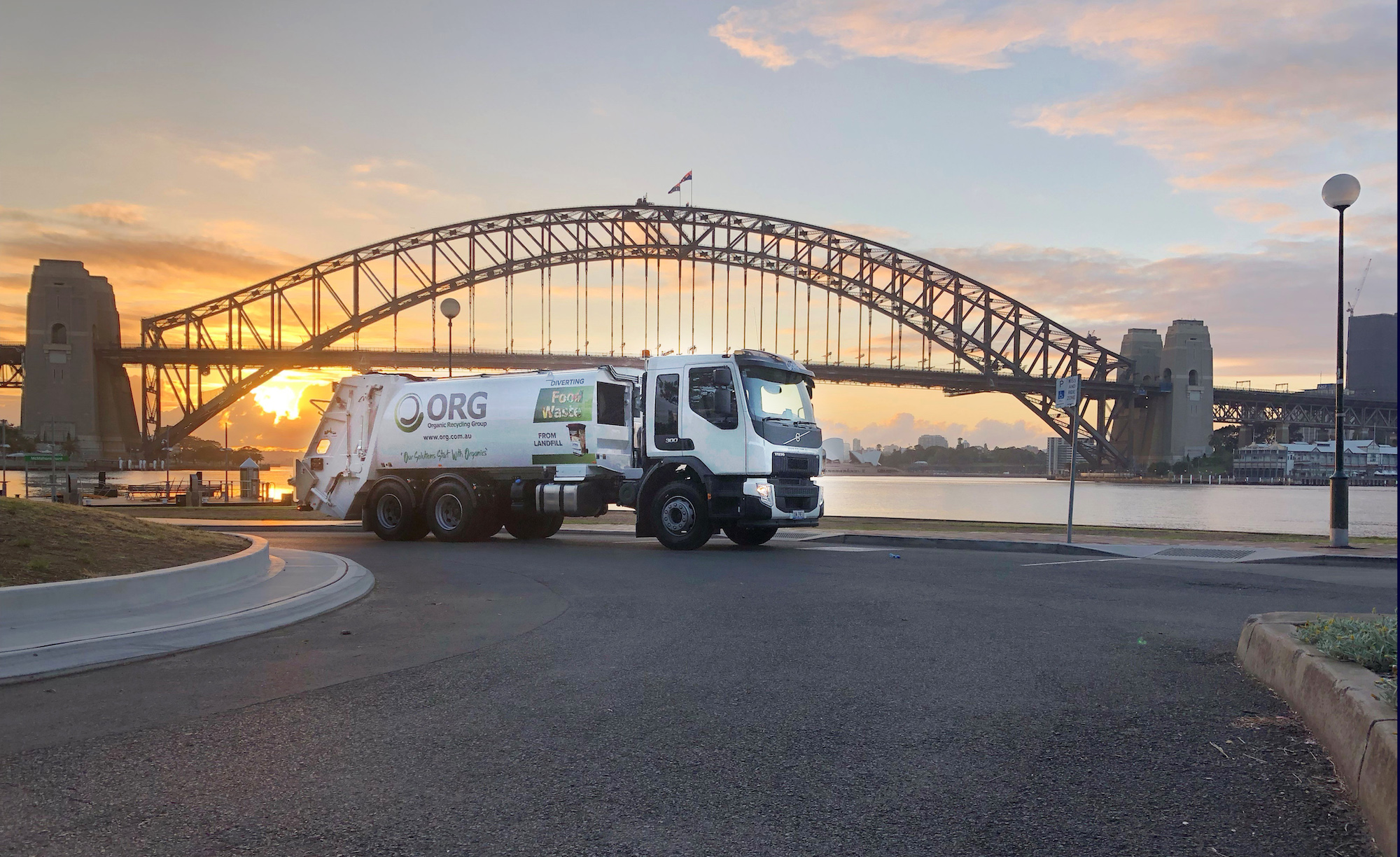 photo of an ORG recycling truck in front of the Sydney Harbour Bridge
