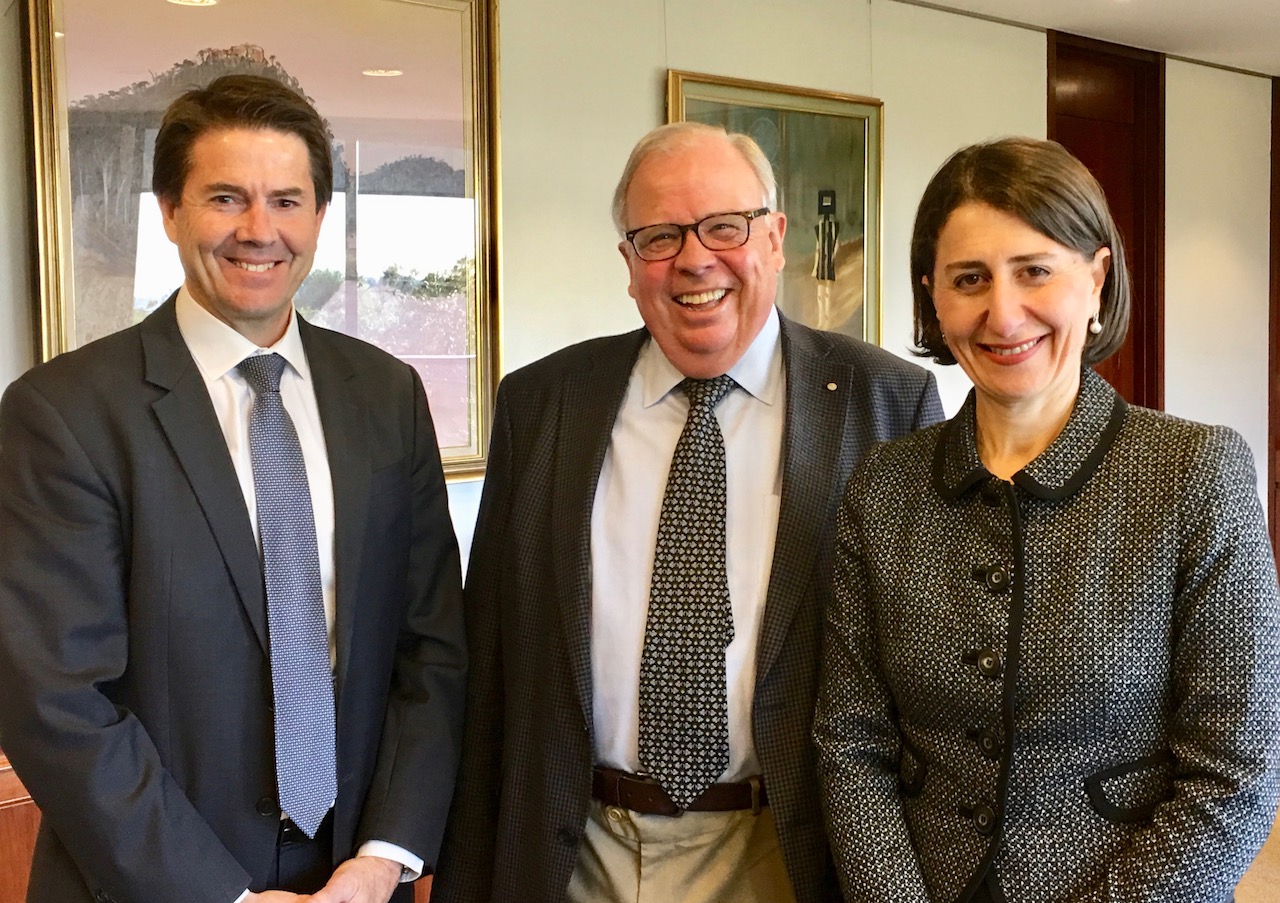 two men and a woman standing