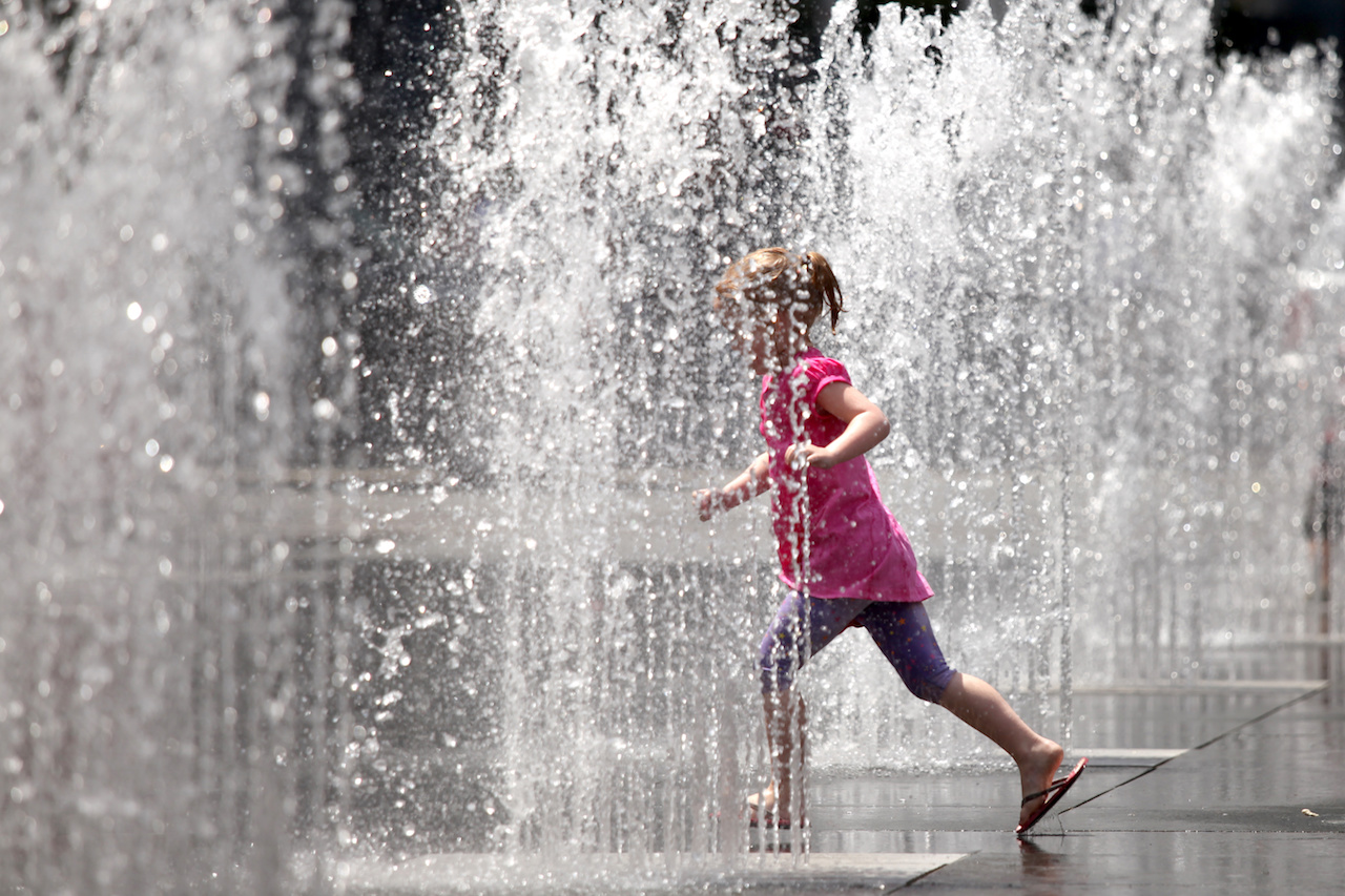 girl Playing in the Water Fountain