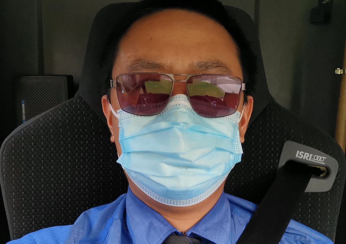 male bus driver wearing mask
