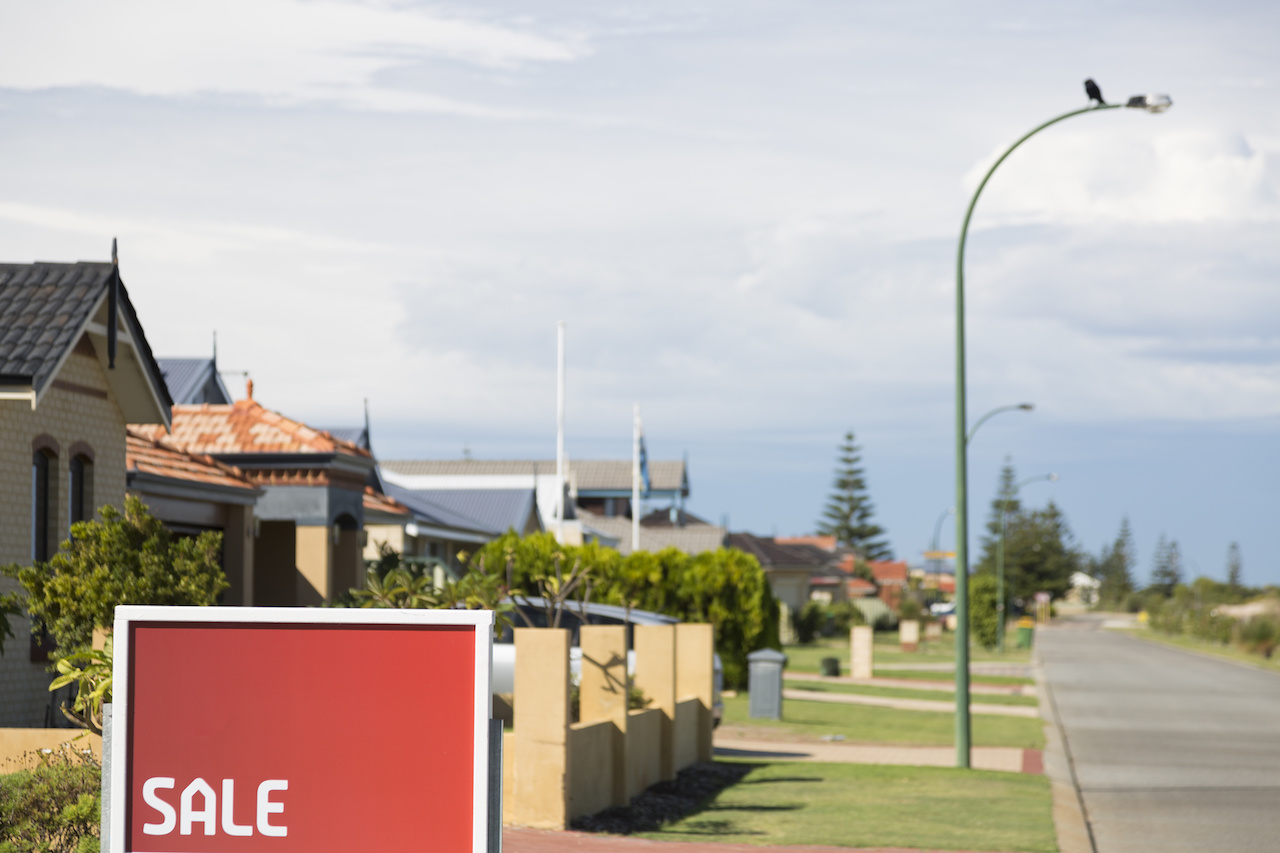 row of houses with for sale sign
