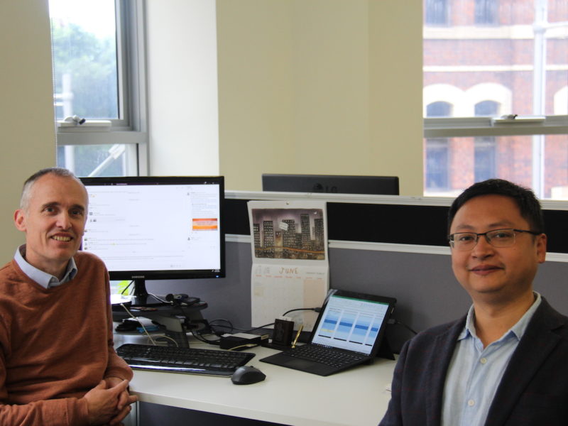 two men in front of a compter