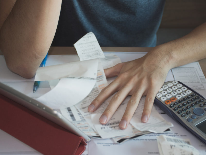 Stressed man with amount to be paid for electricity,financial problem