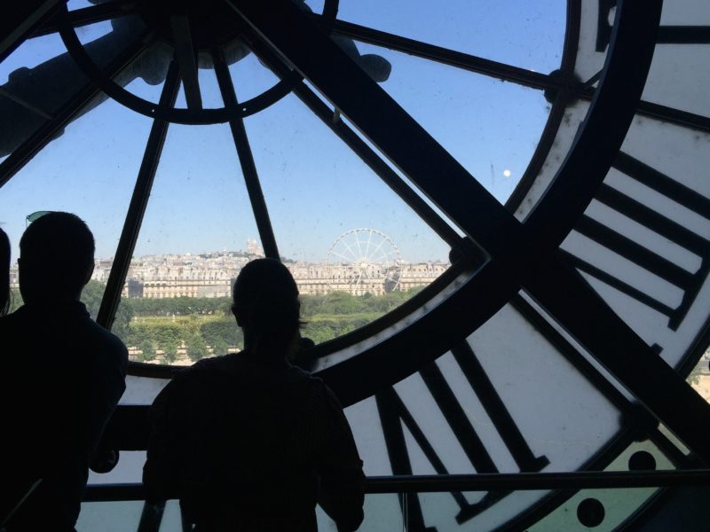 Tourists near the huge clocks in paris