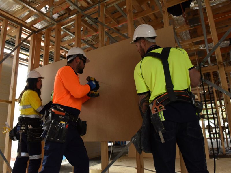 three construction workers on a site