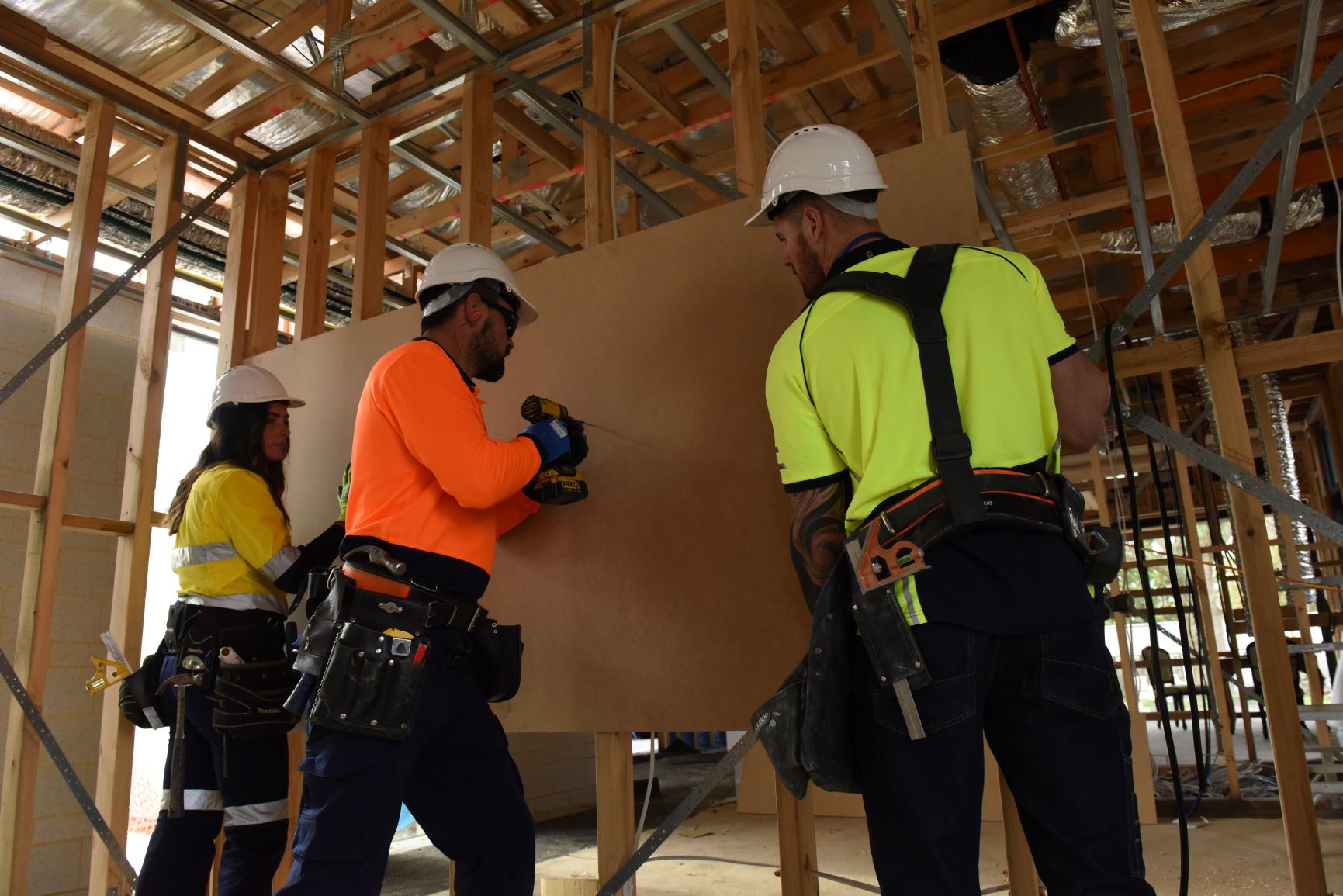 three construction workers on a site