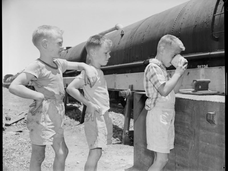 close up of children drinking water from water train