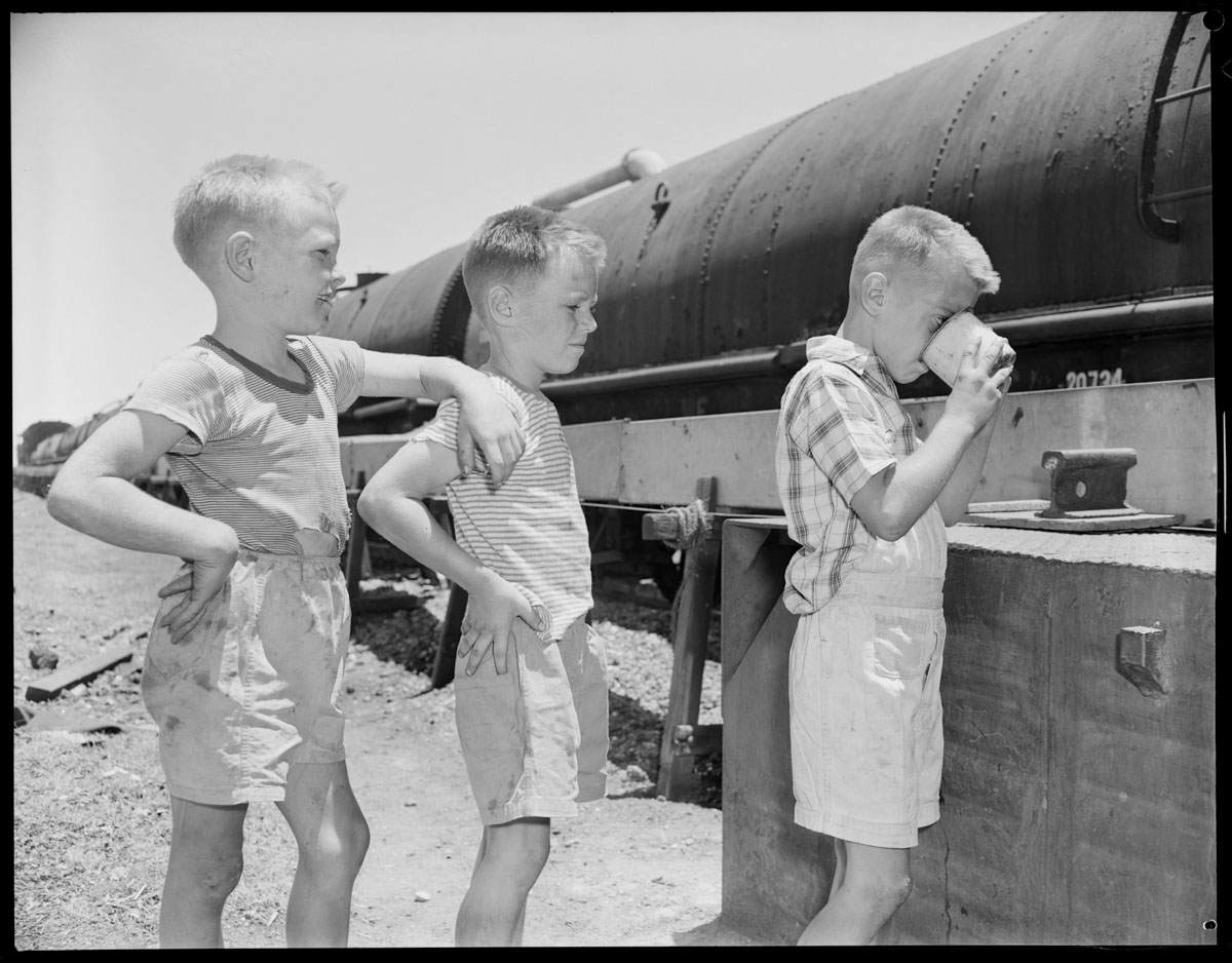 close up of children drinking water from water train