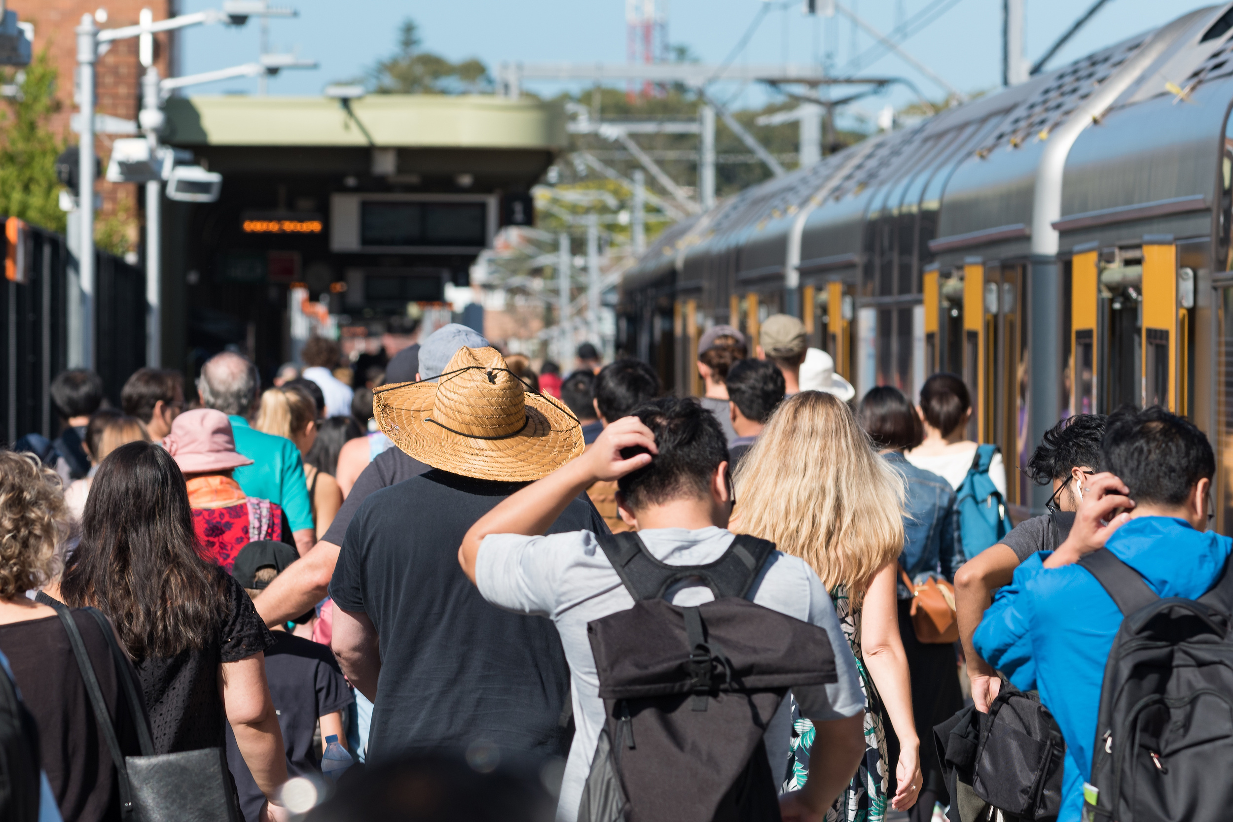 Train station with crowd of unrecognizable people. Rush hour public transport commute