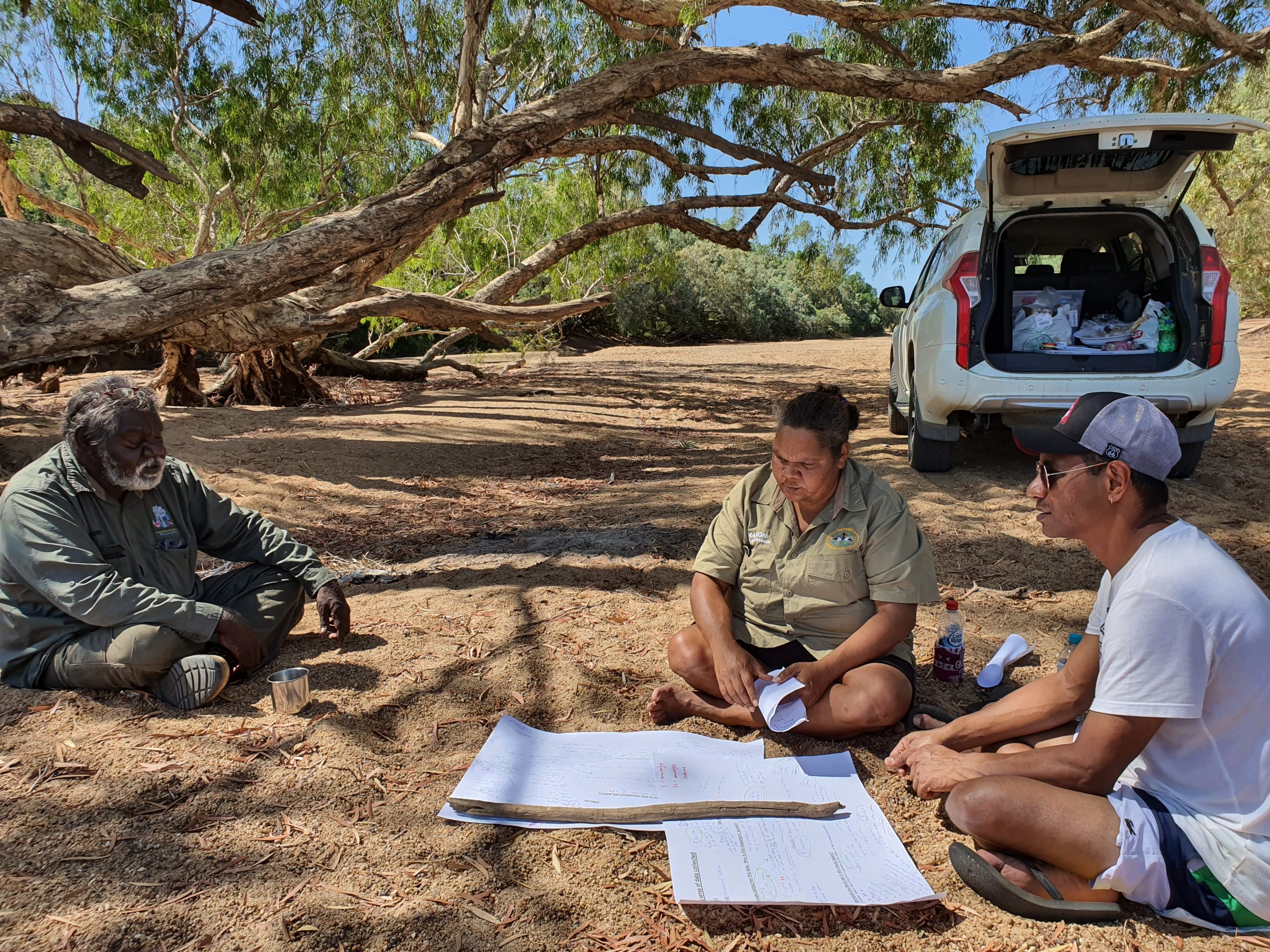 Mapoon verifiers Jason Jia and Sarah Barkley talking with Kowanyama senior elder John Clark