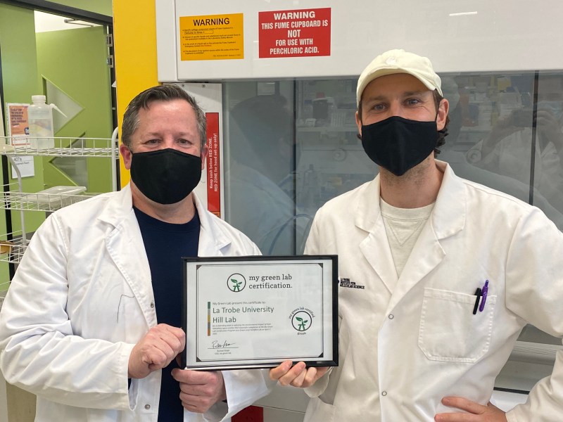 Two men holding an award