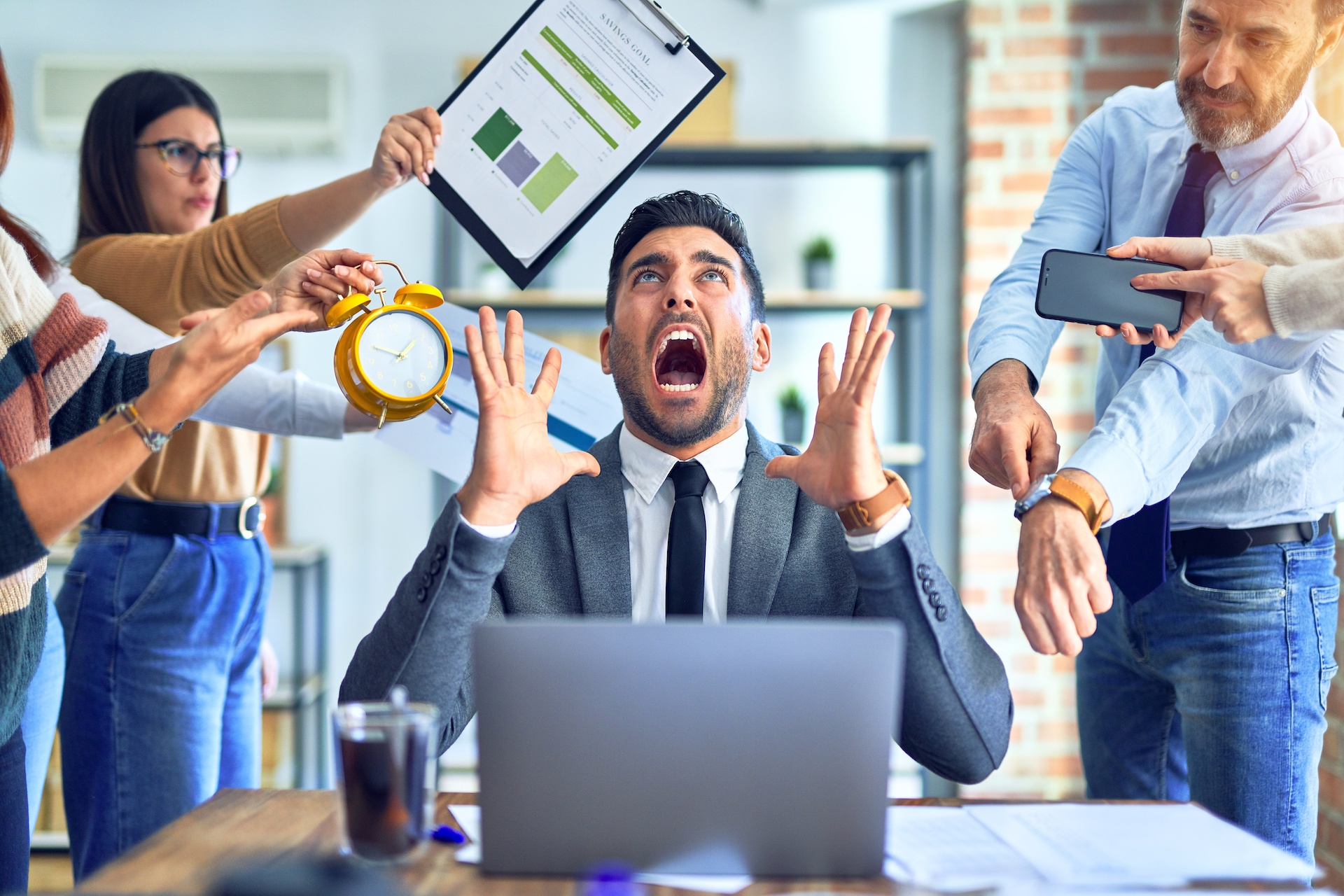 Group of business workers working together. Partners stressing one of them at the office