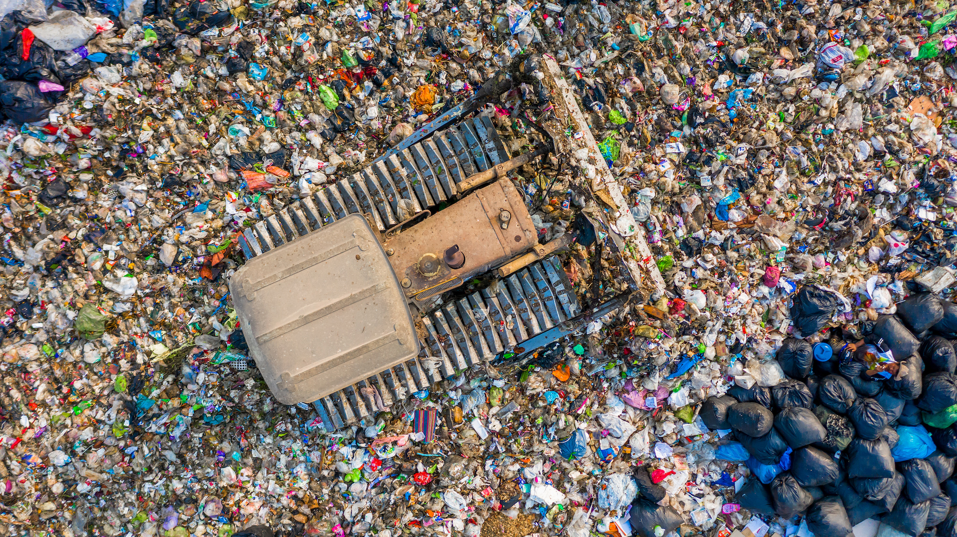 Garbage pile in trash dump or landfill, Aerial view garbage trucks unload garbage to a landfill, global warming.