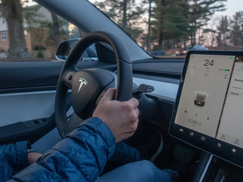 Washington, DC, USA - January, 31, 2020: Man driving Tesla car. Inside cabin view.