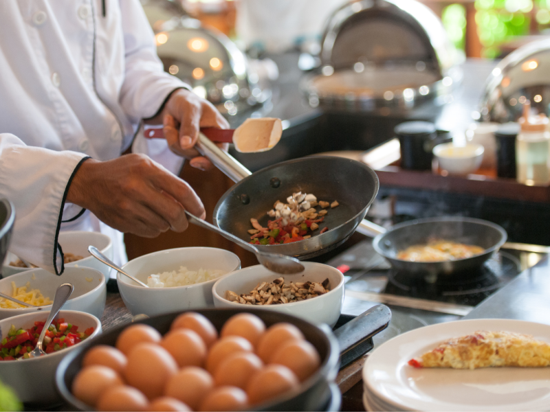 professional chef cooking on an induction electric cooktop
