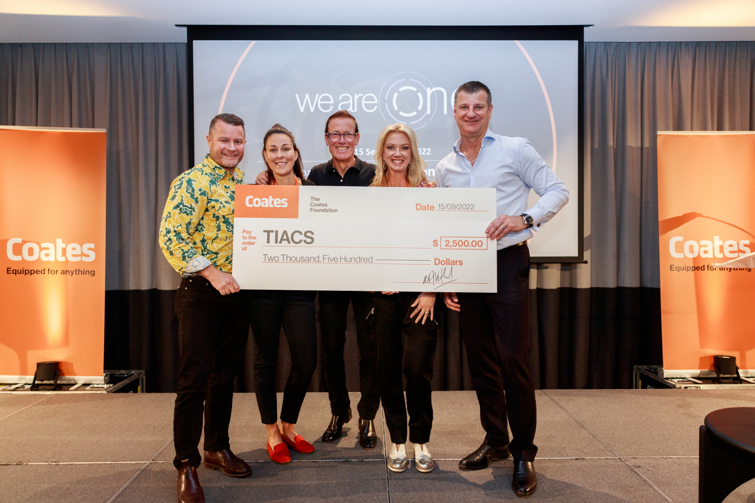 cheque being presented on stage