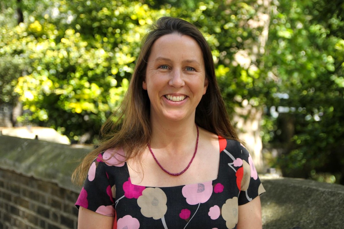 woman smiling against garden backdrop