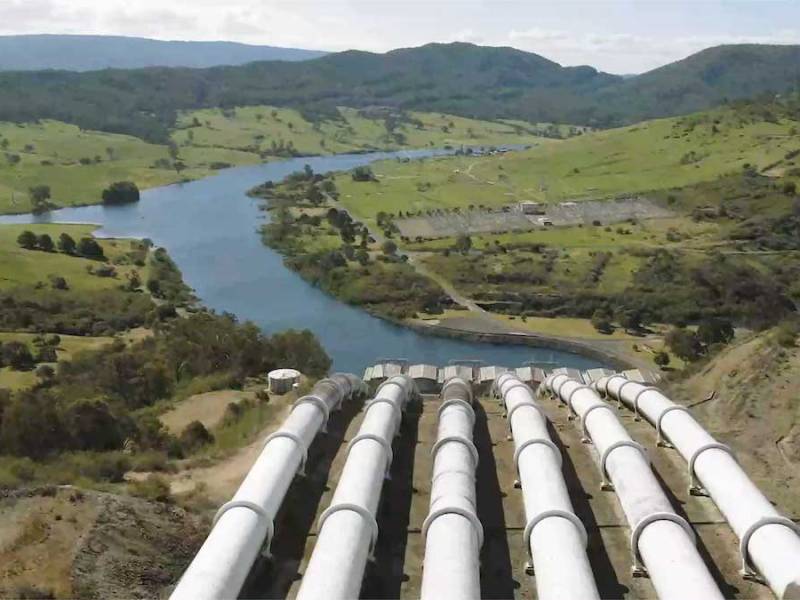 Snowy Hydro hydroelectric dam with green hills in the background