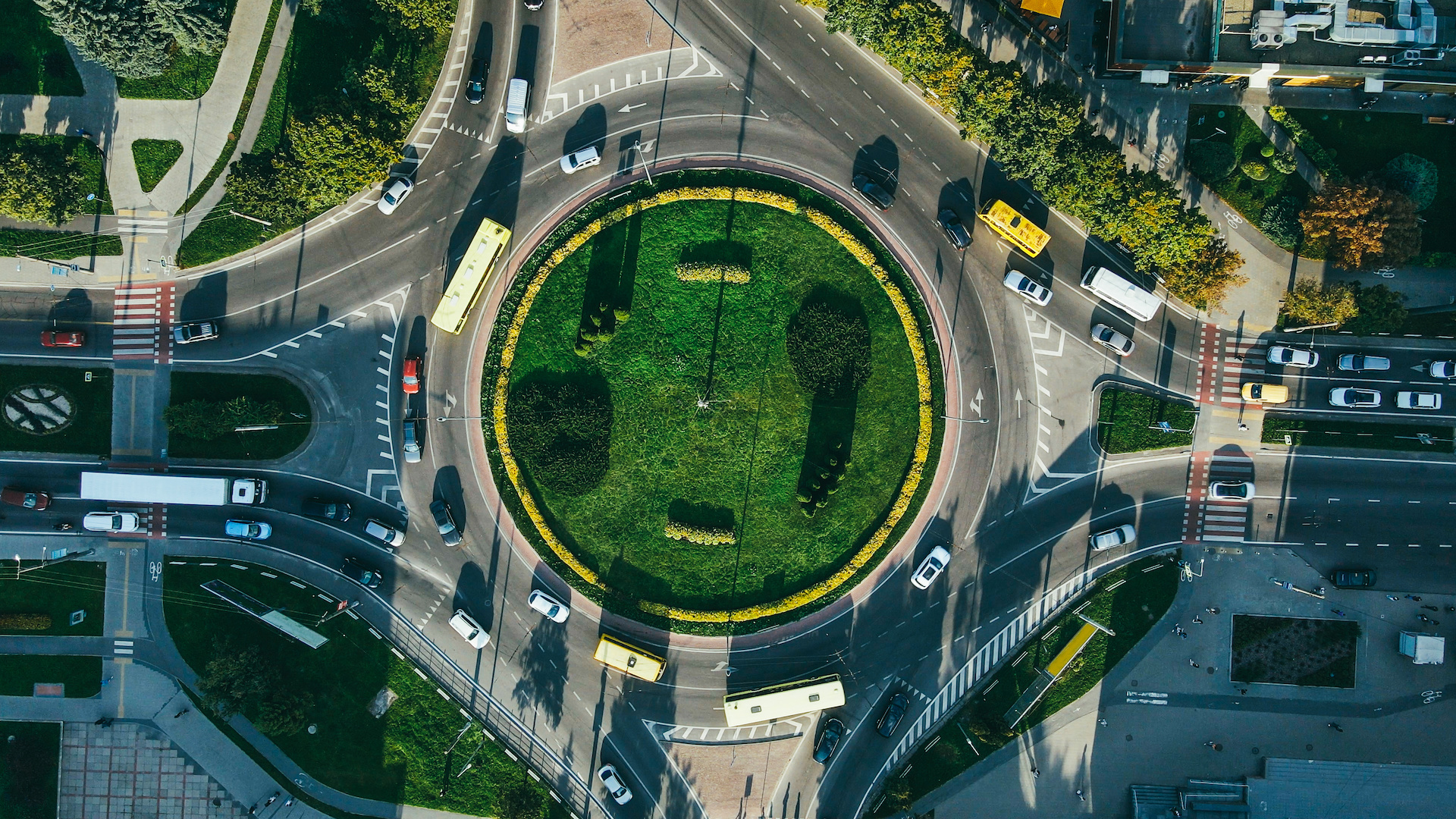 Top view of traffic and people, cars and buses at rush hour at circular junction. High quality photo