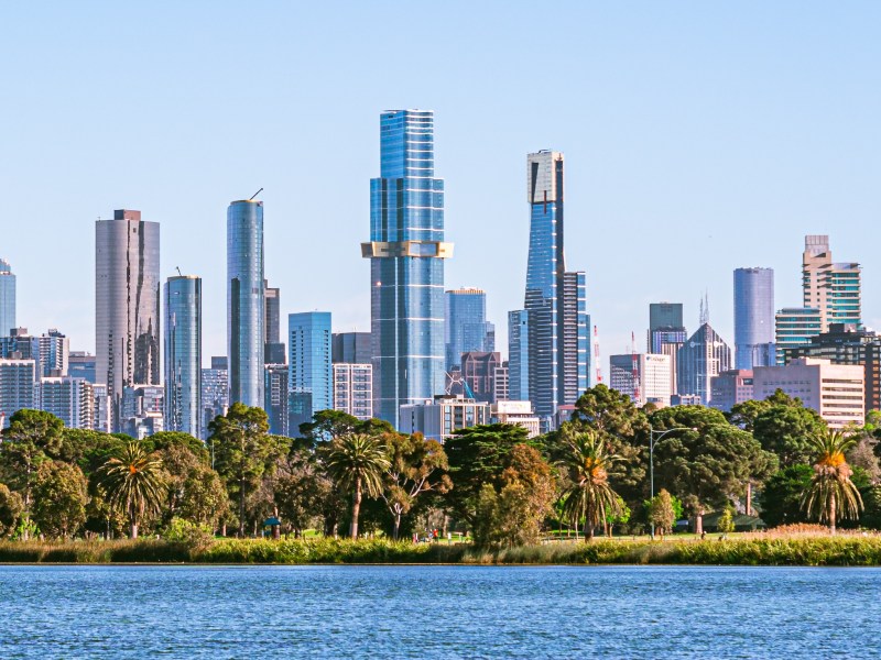 Melbourne cityscape with skyscrapers, blue sky and Yarra River.